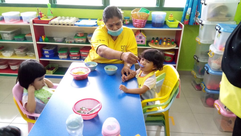 Children at the home being fed.