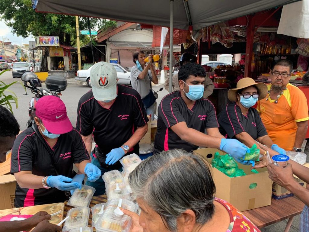 The needy collecting their food packets at the Goddess of Mercy Temple.