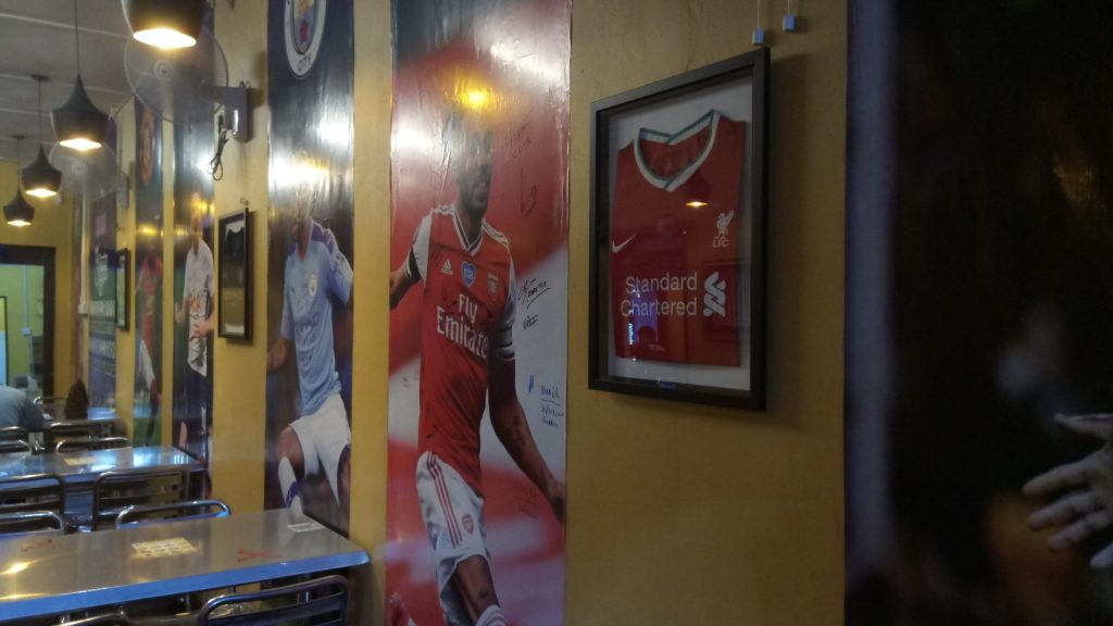 Life size posters adorn the wall.