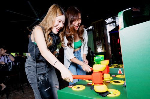 Guests participating in the Work Buster game at The Ghosted Bar experience